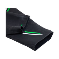 Close-up of BASIC wetsuit ankle opening showing flexible black neoprene with green and white detailing.
