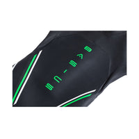 Close-up of BASIC wetsuit torso showing green logo and panel design on black neoprene.