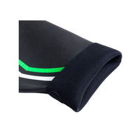 Close-up of BASIC wetsuit wrist cuff showing soft inner lining and flexible black neoprene with green and white accents.