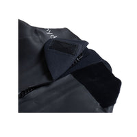 Close-up of BASIC wetsuit neck closure with Velcro strap and zipper on black neoprene.