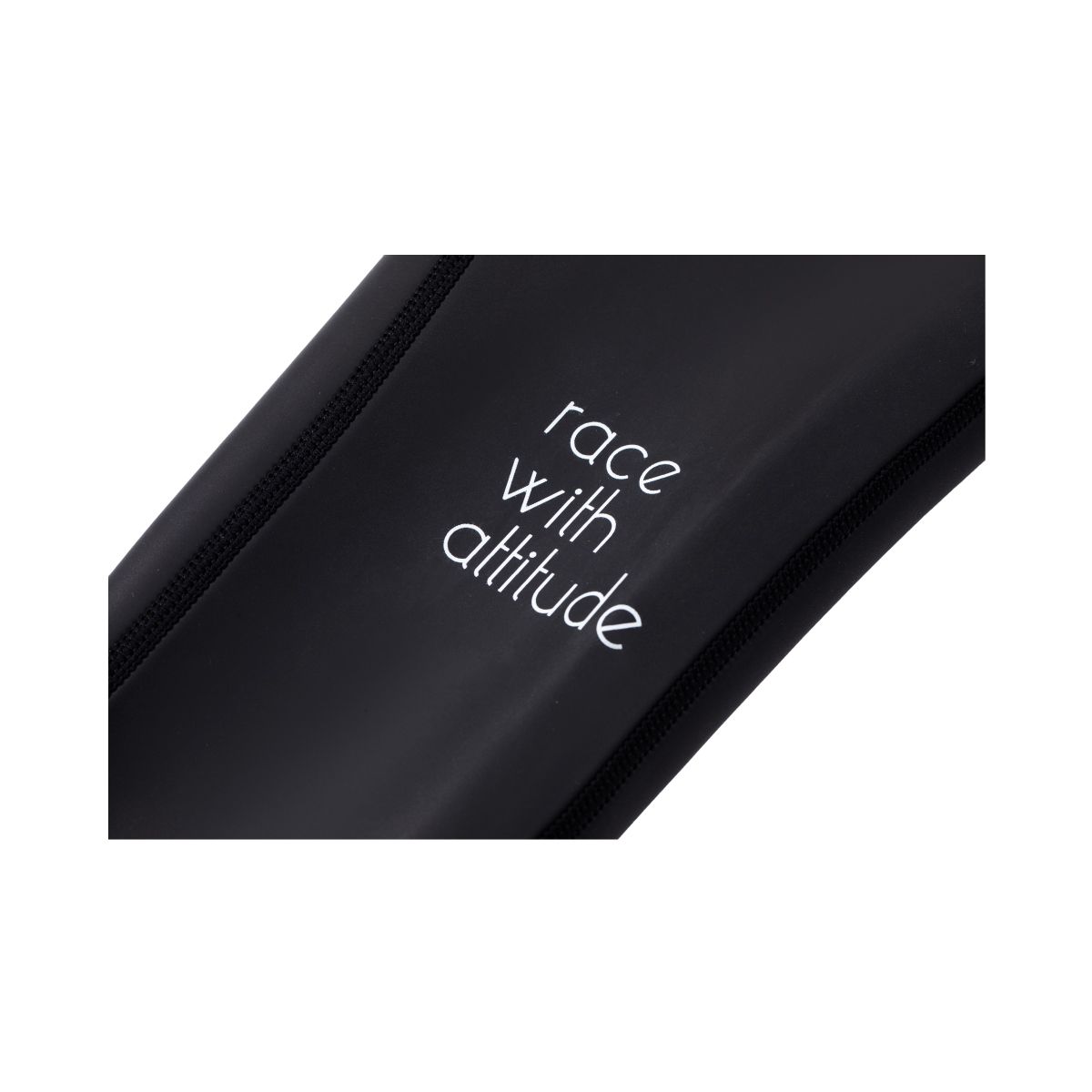 Close-up of ONE wetsuit leg panel showing ‘race with attitude’ text on black neoprene.