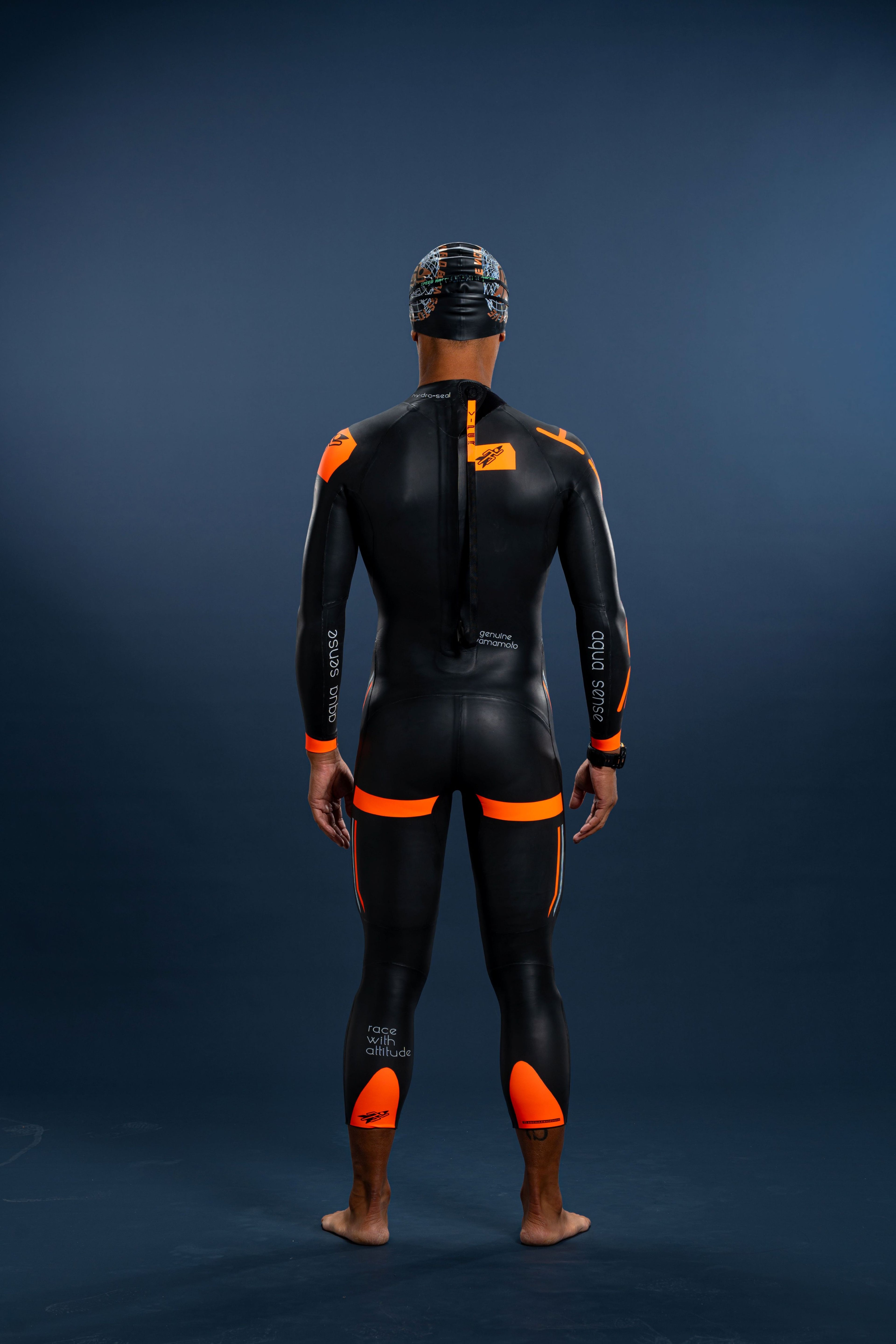 Back view of male swimmer wearing Rocket Science Sports men’s long-sleeve wetsuit with orange panels and rear zipper