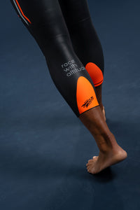 Close-up of Rocket Science Sports Aquasense wetsuit lower leg showing orange calf panel with logo and ‘race with altitude’ branding