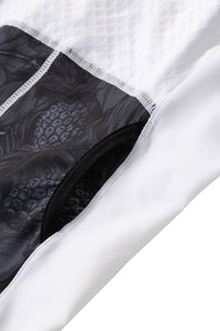 Close-up of a white garment with black floral patterned lining on a white background